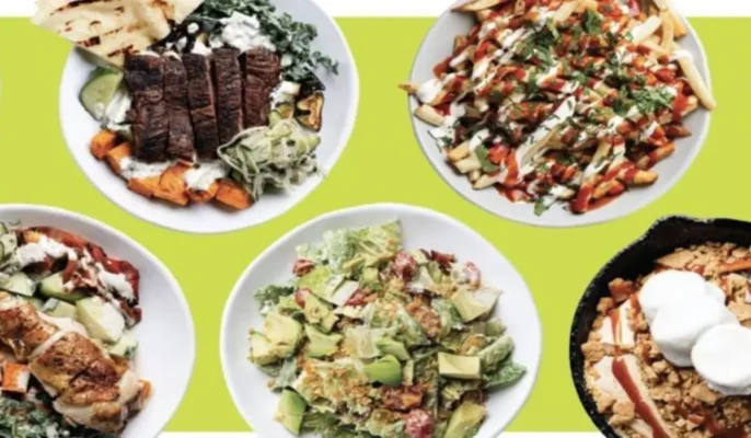 Overhead view of six plated dishes from Chicken N Pickle’s updated menu, including grilled meats, fresh salads, seasoned fries, and a skillet dessert. These represent the brand’s new lighter, globally inspired offerings for its 2025 menu overhaul.