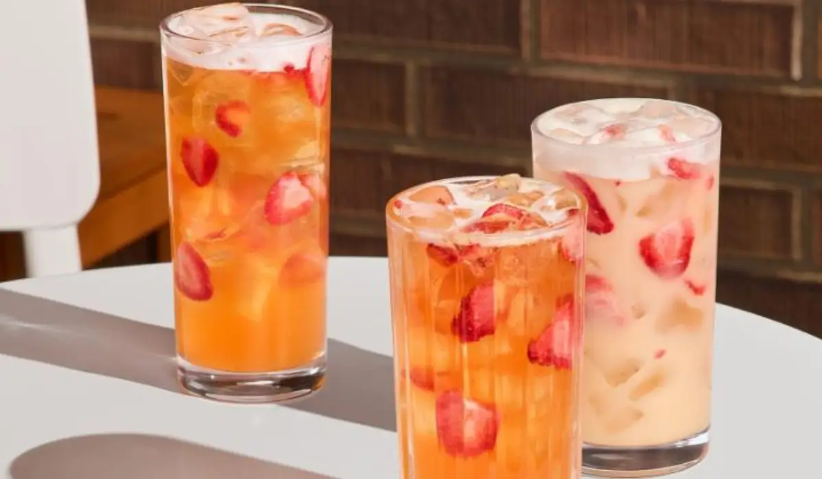 Three iced strawberry refreshers drinks with fruit pieces showcasing colorful spring beverage trends in restaurants