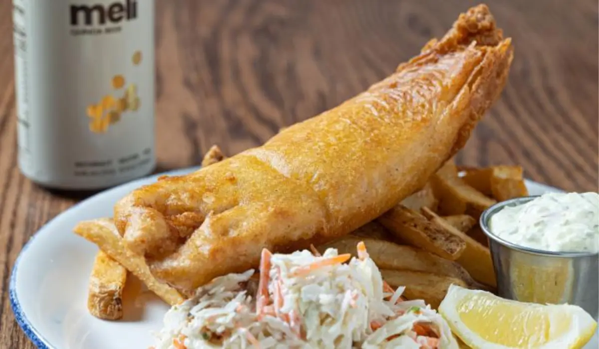 Gluten-free beer-battered fish and chips with fries, coleslaw and tartar sauce served at Legal Sea Foods.